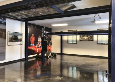 metalic epoxy floor coating with car lifter